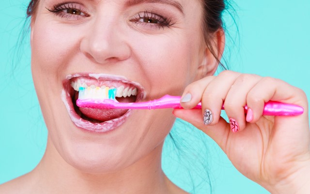 20800102-woman-brushing-cleaning-teeth.jpg